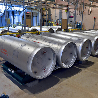 Chlorine canisters are stacked for use in a drinking water plant.