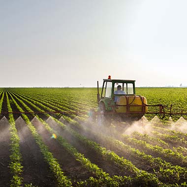 A farm tractor fertilizes crops introducing nitrogen in the form of ammonia.